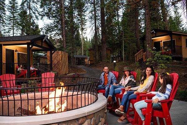Family and dog around firepit at Tenaya Lodge in Yosemite