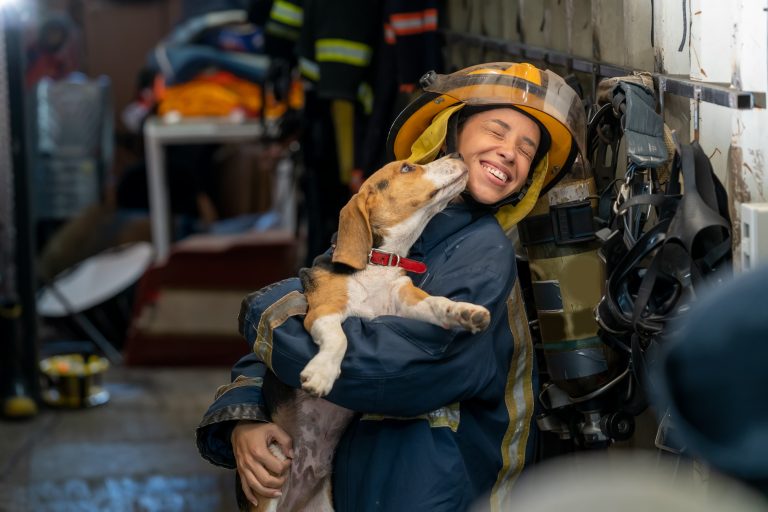 Woman firefighter holding a dog